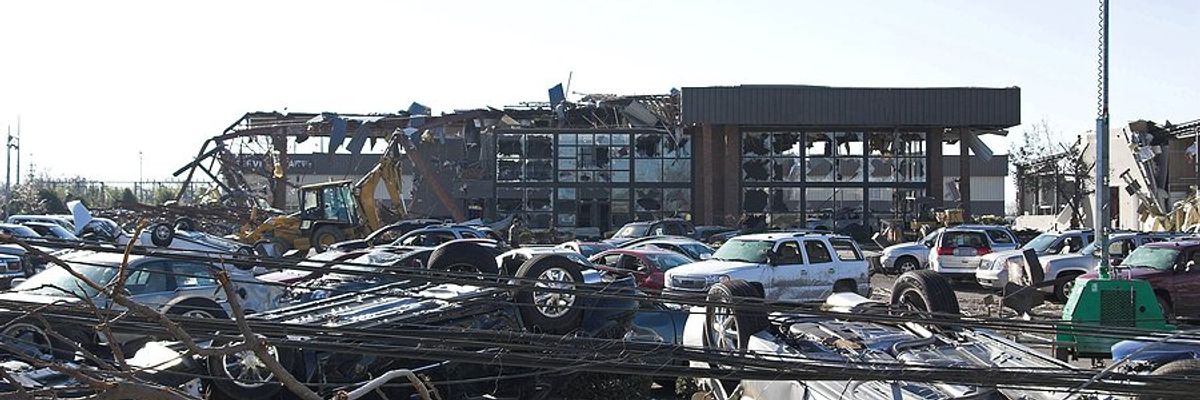 A damaged business with overturned cars.