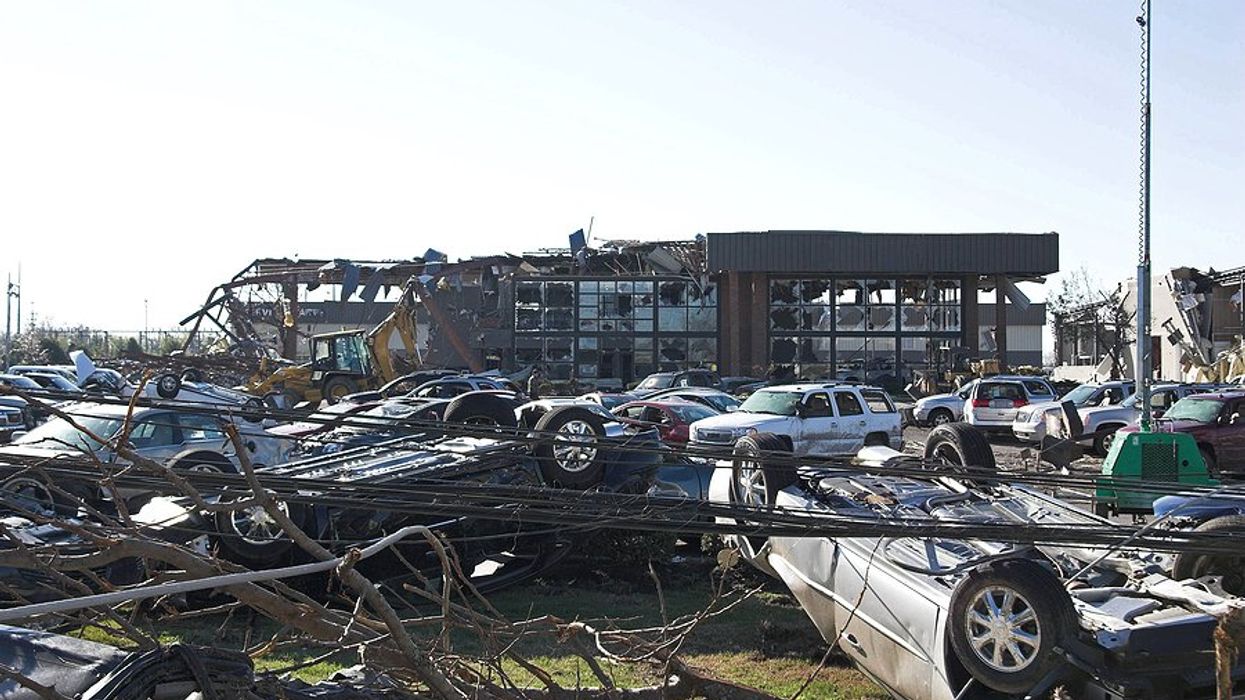 A damaged business with overturned cars.