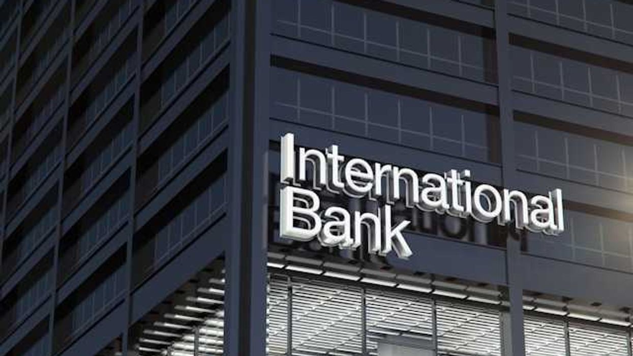 A dark gray office building with the words International Bank on the side