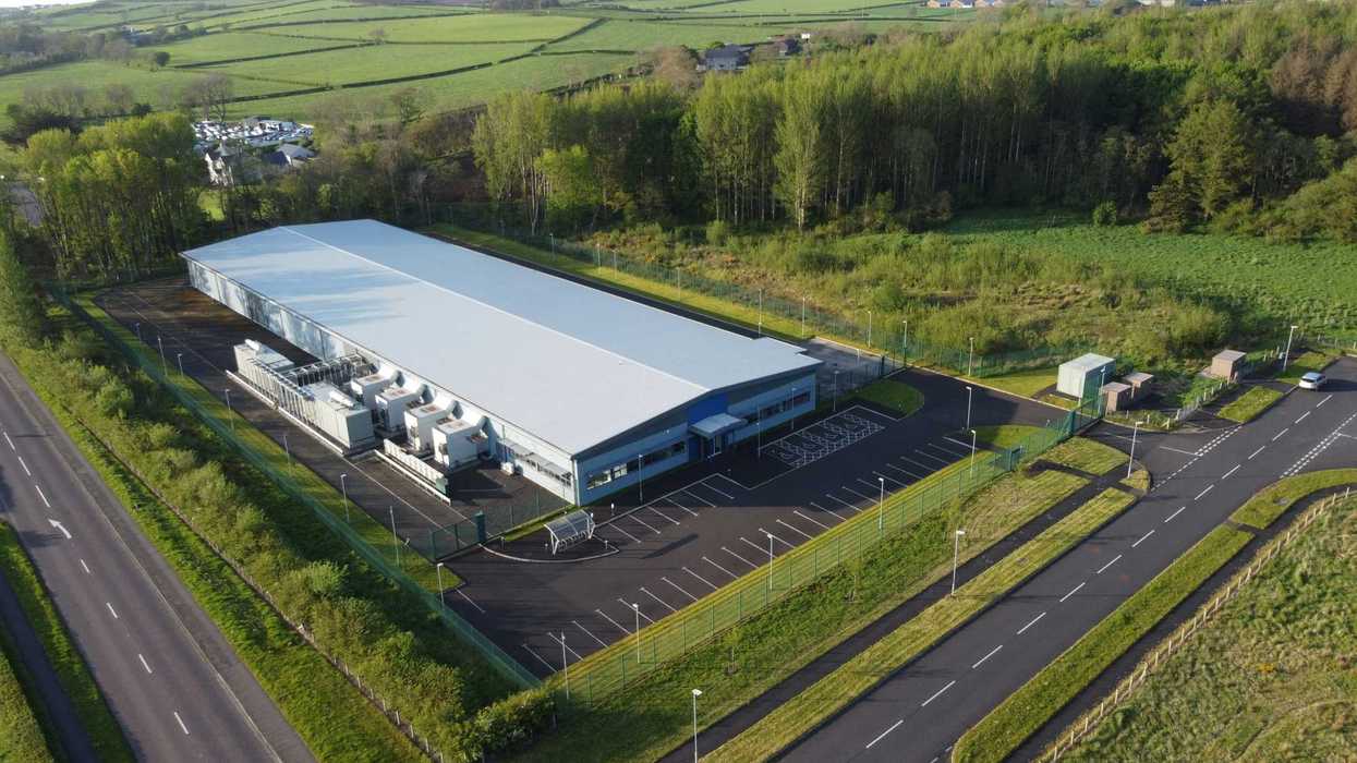 A data center surrounded by trees green fields and roads.