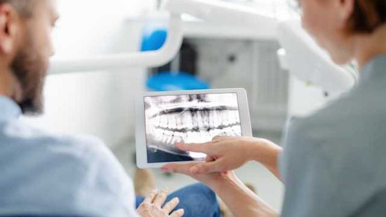 A dentist showing a patient his xrays