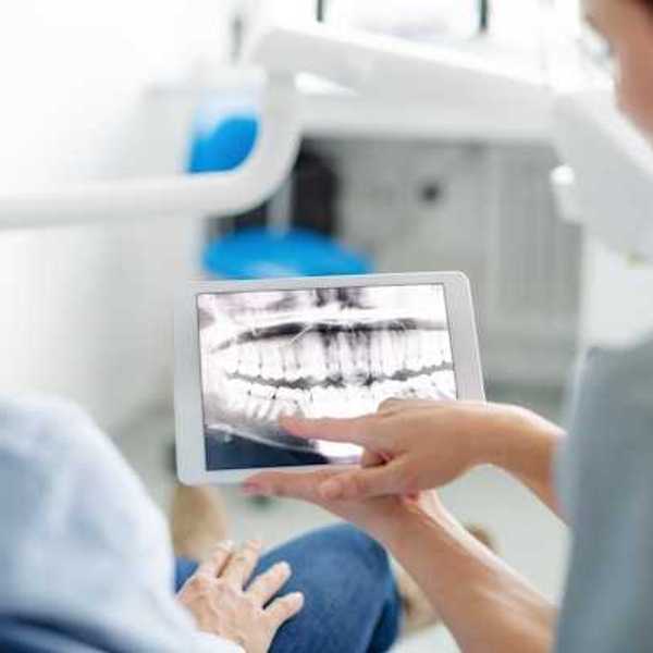 A dentist showing a patient his xrays
