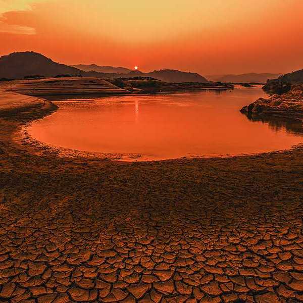 A drying lakebed under a setting sun