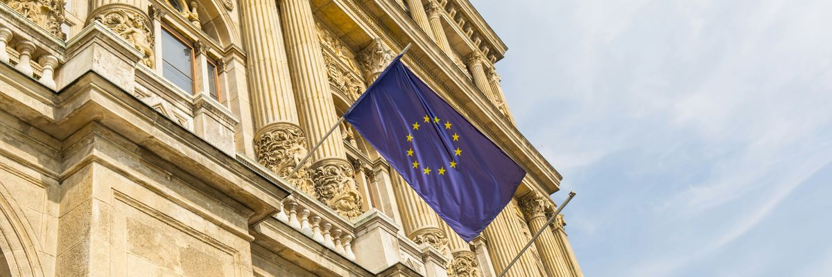 a european flag flying in front of a building