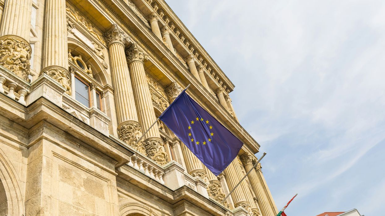 a european flag flying in front of a building