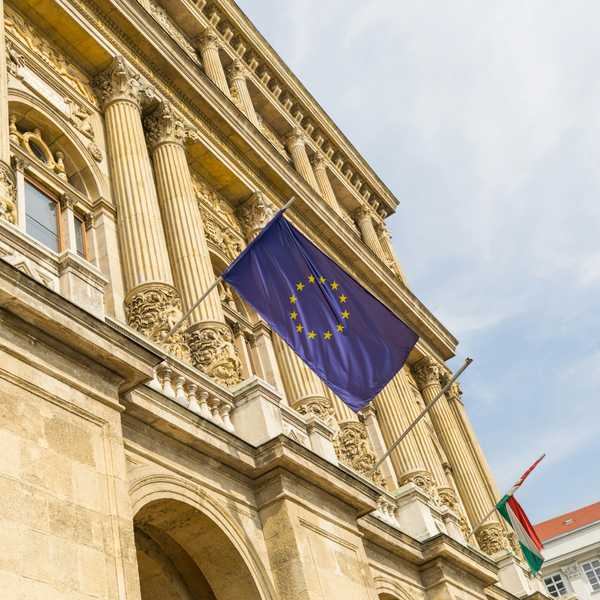 a european flag flying in front of a building