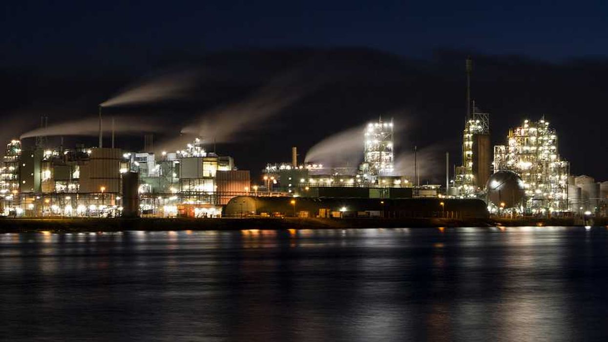 A factory at night on the edge of a river