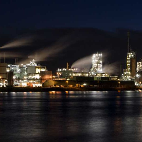 A factory at night on the edge of a river