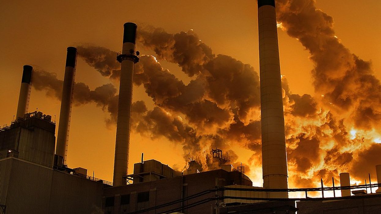A factory or power plant with smokestacks emitting pollution