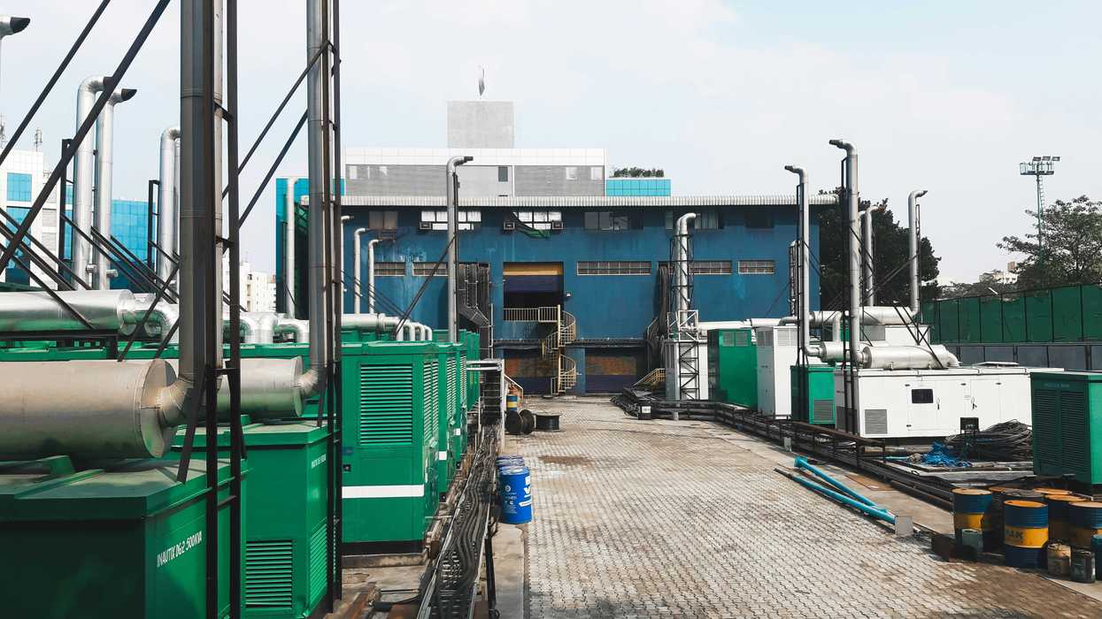 a factory with a lot of green and white generators on platforms outside