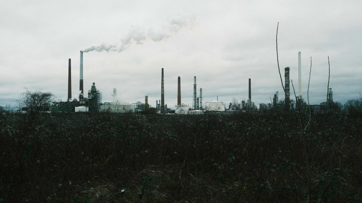 a factory with smoke coming out of its stacks
