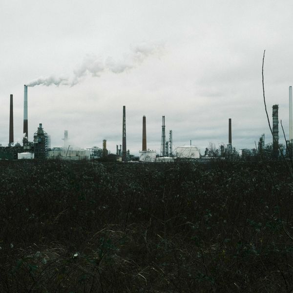 a factory with smoke coming out of its stacks