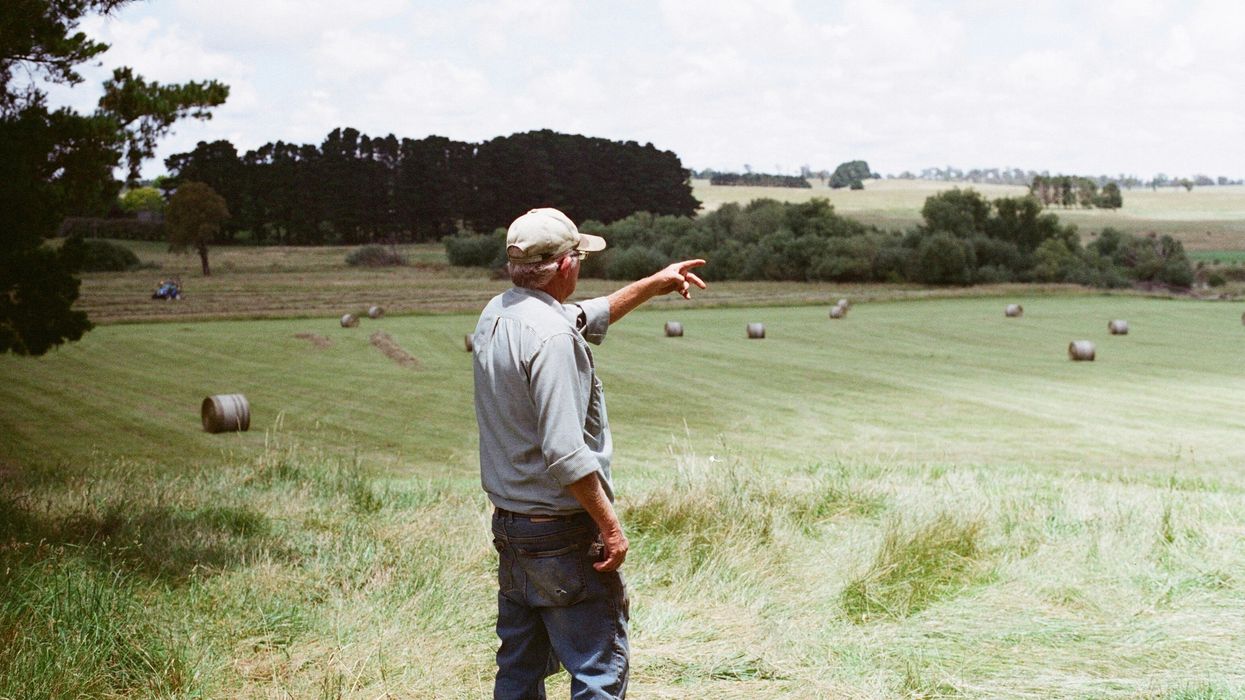 A farmer pointing towards his fields