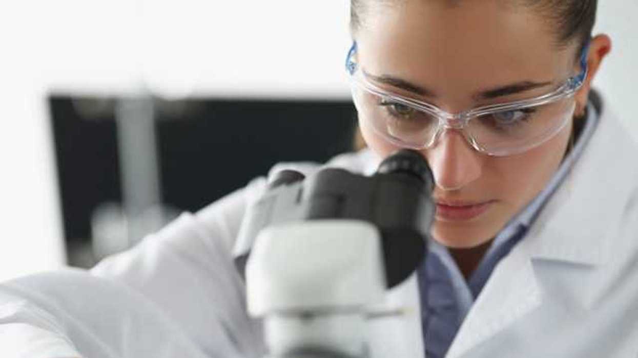 A female scientist looking into a microscope