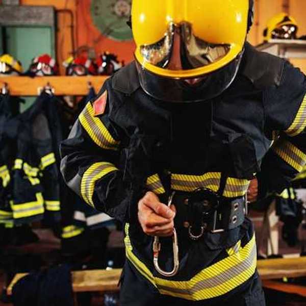 A firefighter putting on his gear