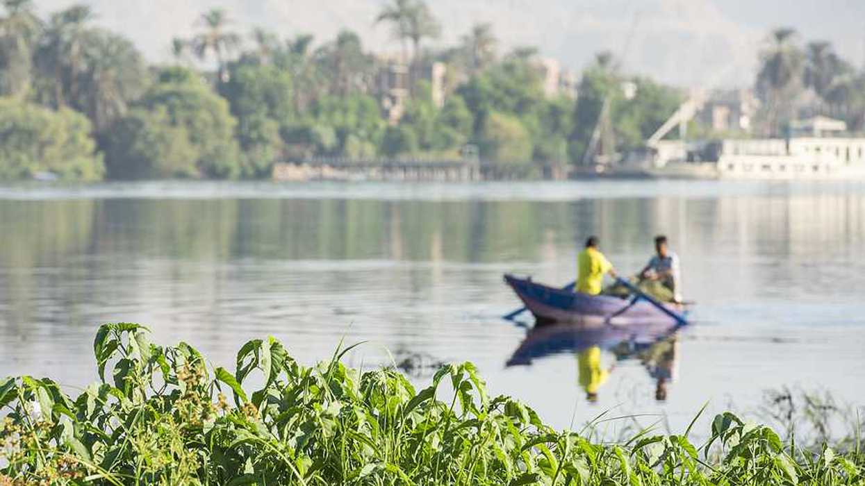 A fishing boat on the Nile River with two fishermen in it