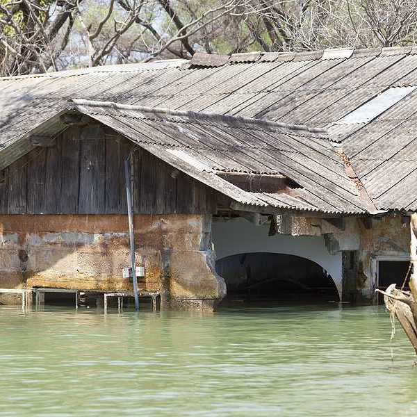 A flooded building with a metal roof