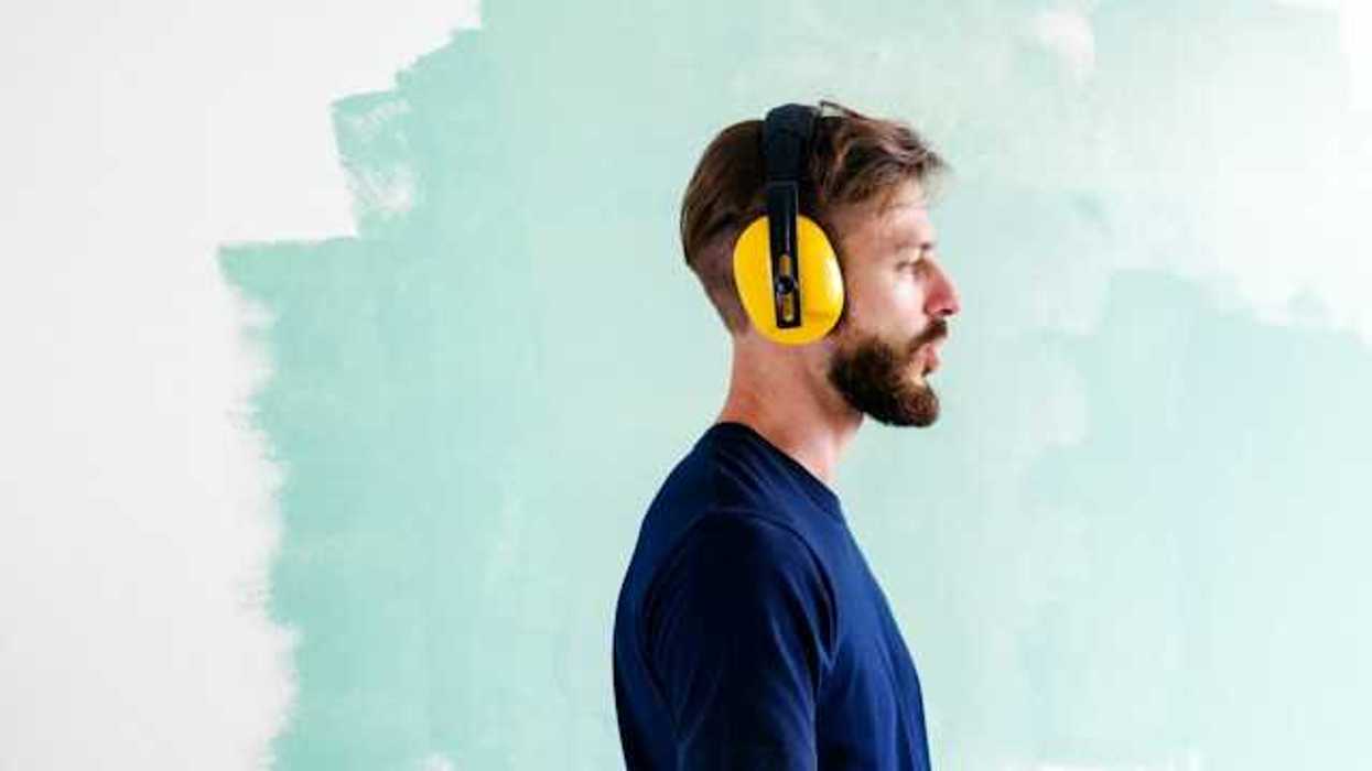 A foreman wearing yellow ear protection