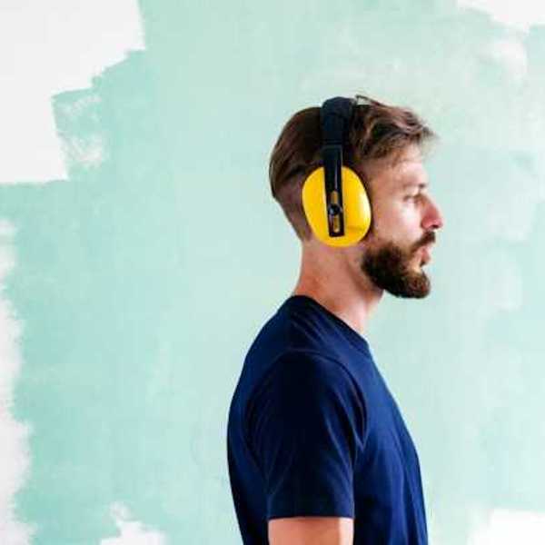 A foreman wearing yellow ear protection