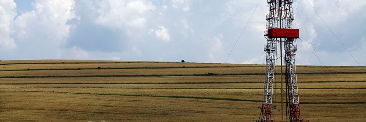 A fracking platform next to a farm field.