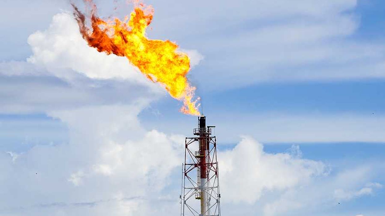 A fracking tower flaring flames into the sky
