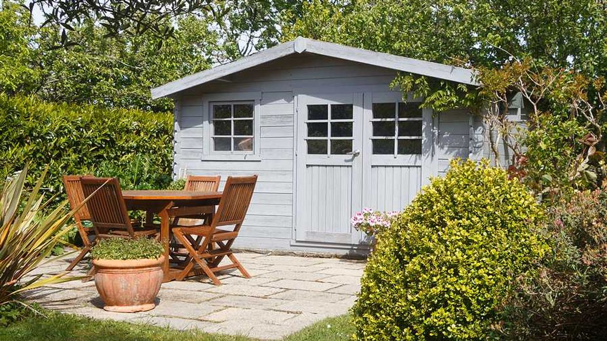 A garden shed with a patio in front of it