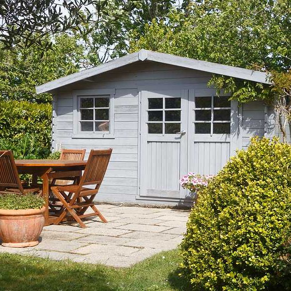 A garden shed with a patio in front of it