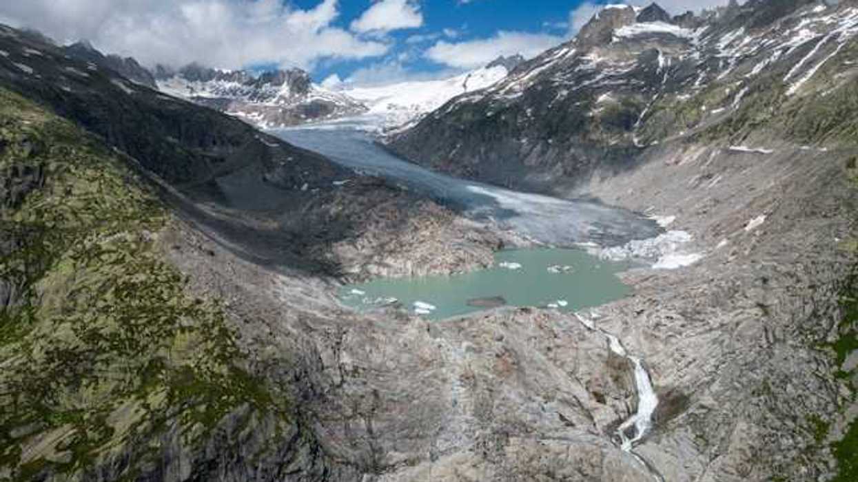 A glacial lake surrounded by snow capped mountains