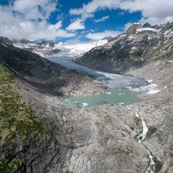 A glacial lake surrounded by snow capped mountains