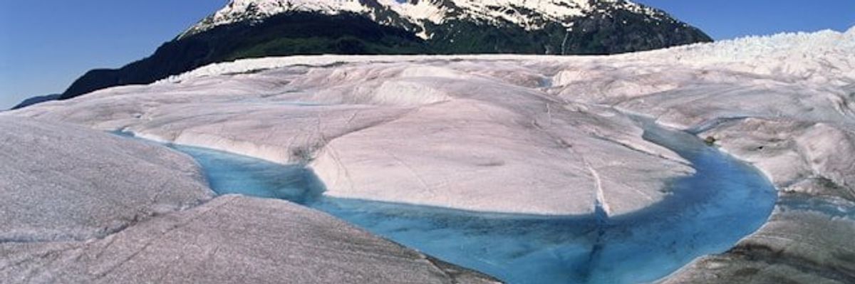 A glacier with a river running through it.
