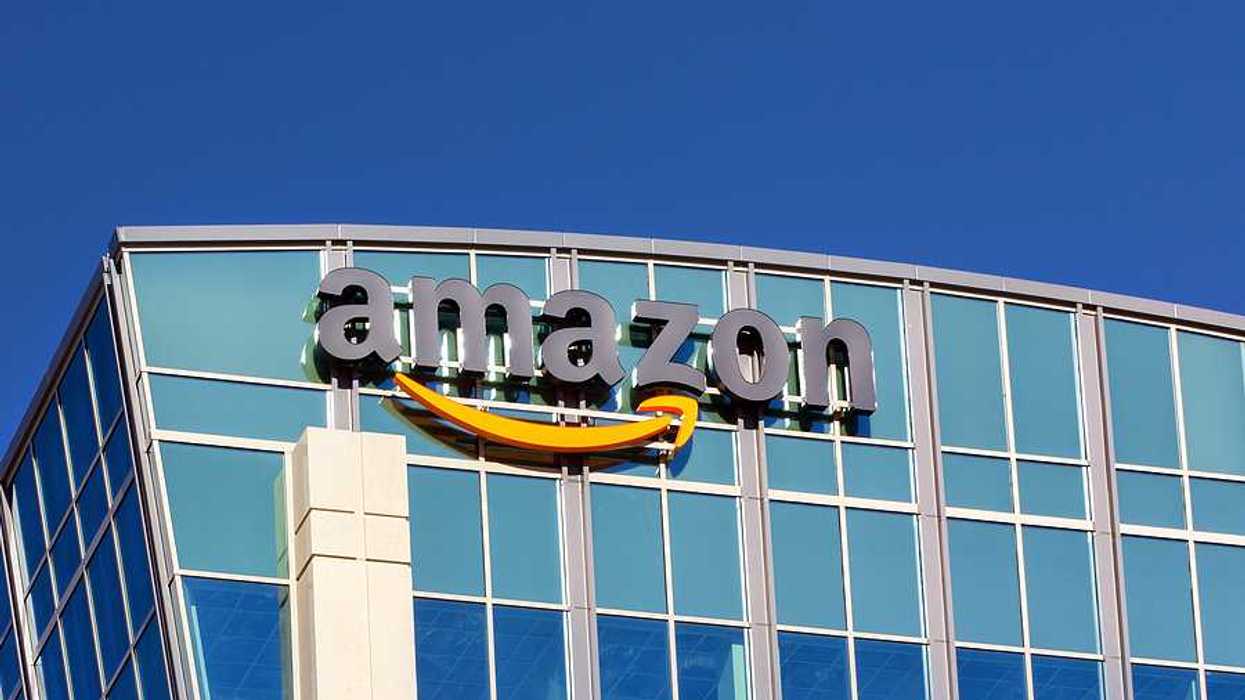 A glass building with the Amazon logo on the side of it