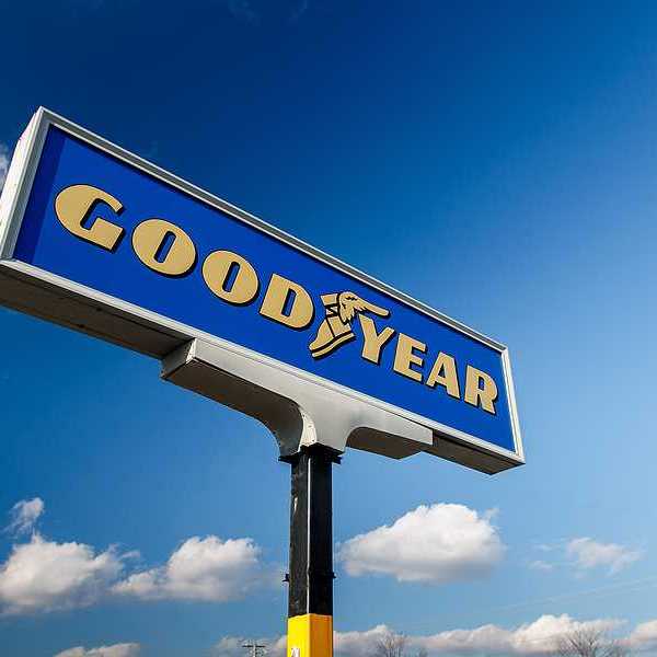 A Good Year sign with logo against a blue sky with clouds