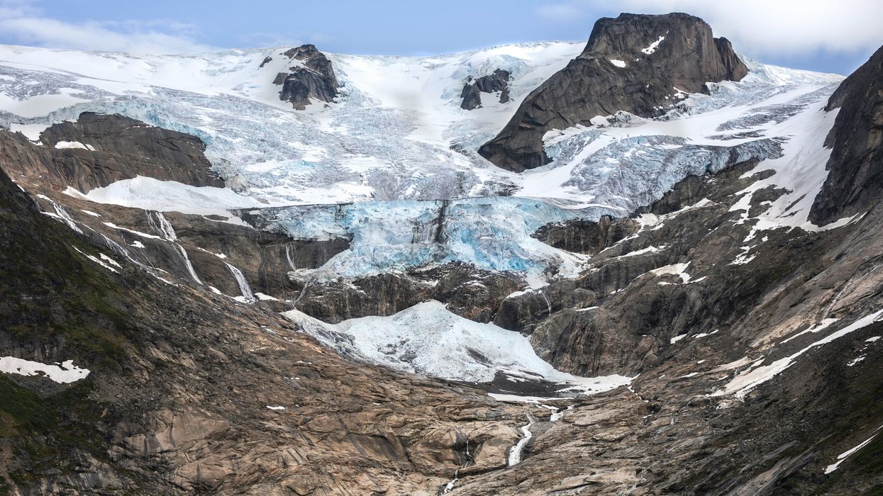 A Greenland glacier receding from a brown and gray valley