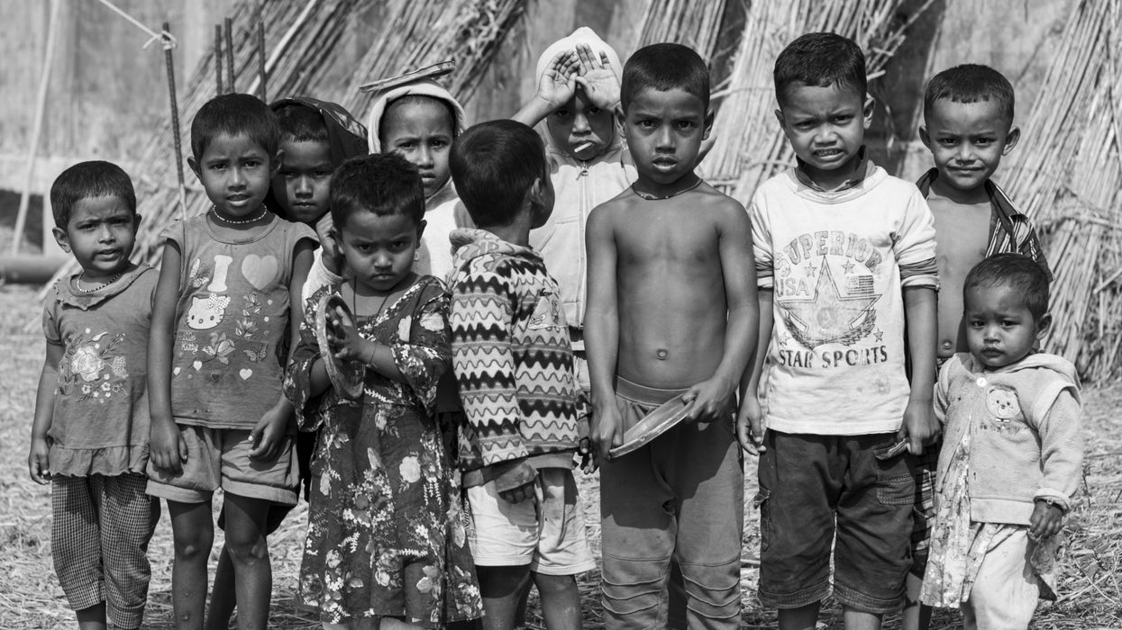 a group of children standing next to each other in a black and white photo