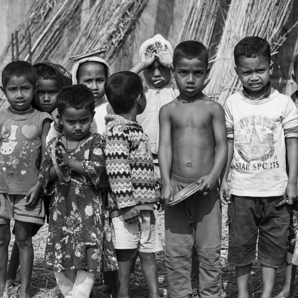 a group of children standing next to each other in a black and white photo