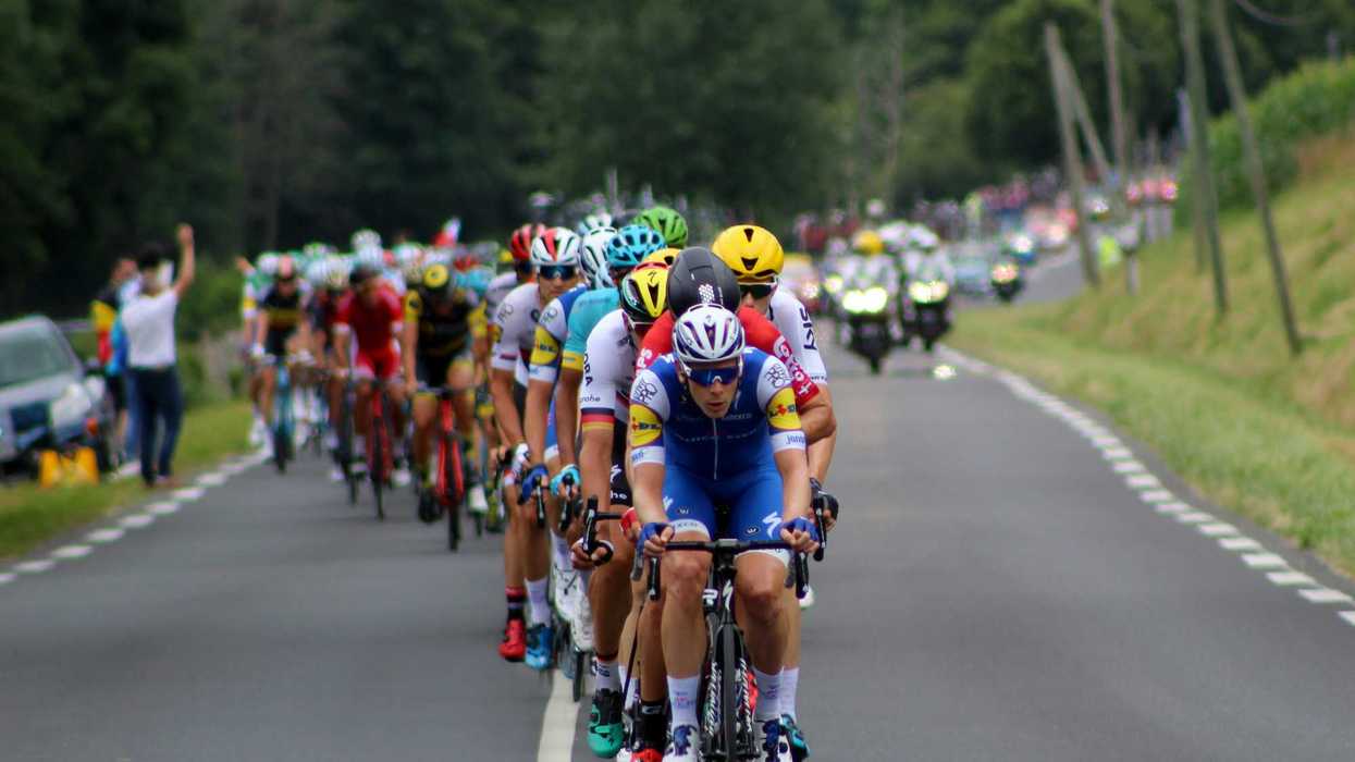 A group of cyclists on a road during a race.