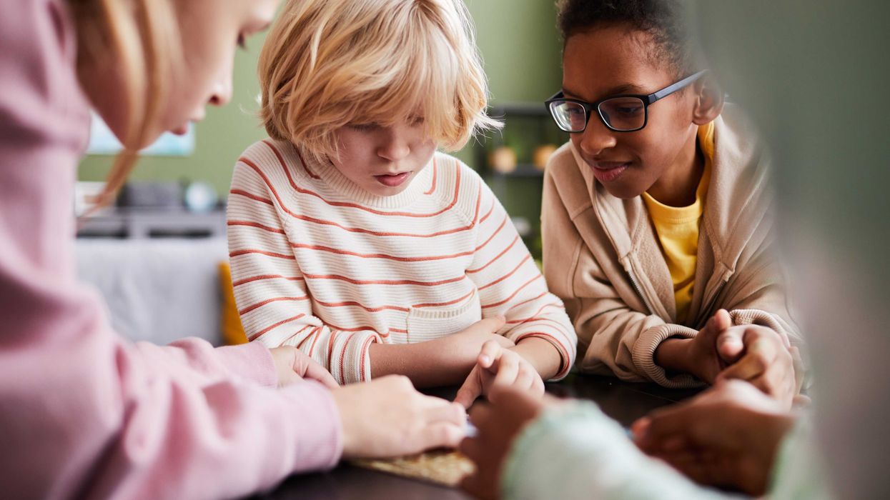 A group of kids play in a tablet