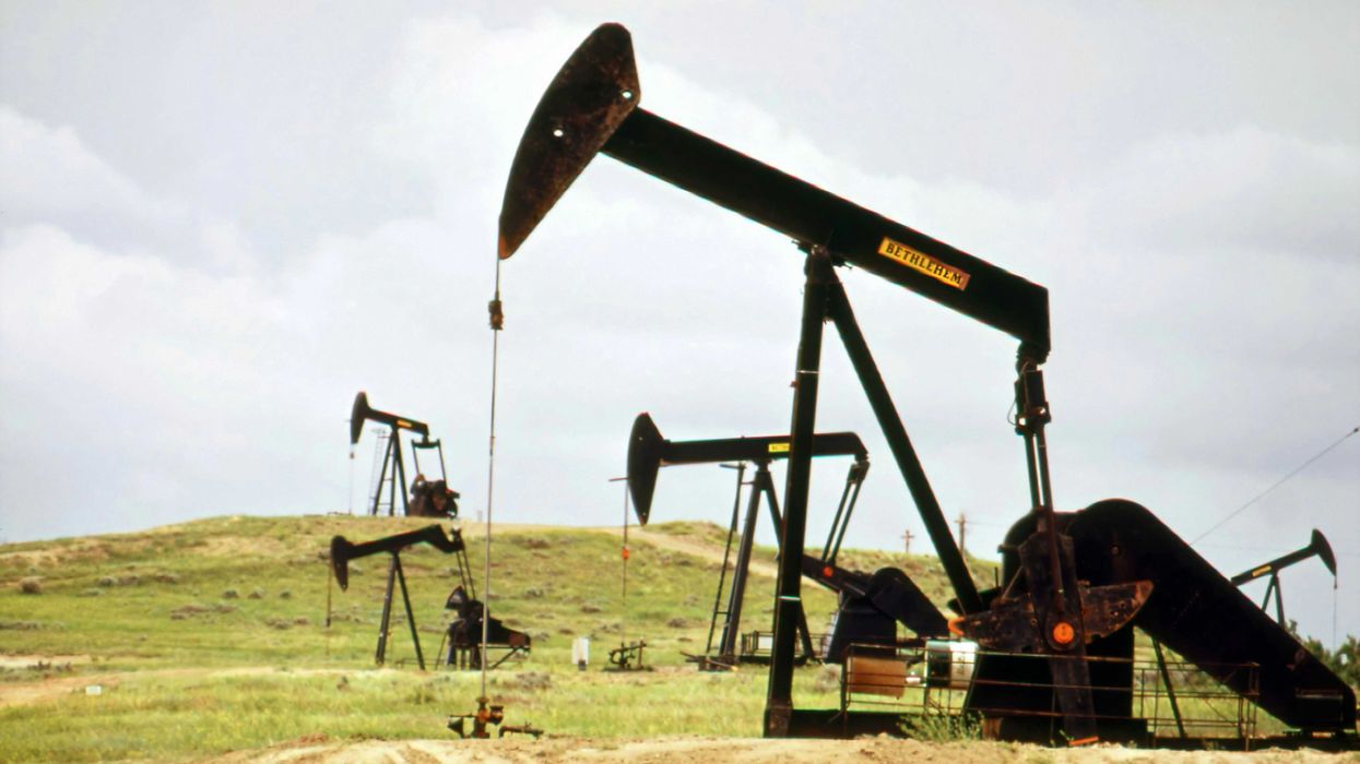 a group of oil pumps sitting on top of a field