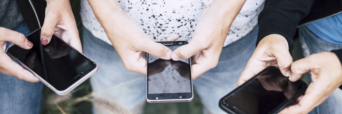 A group of people on their cell phones