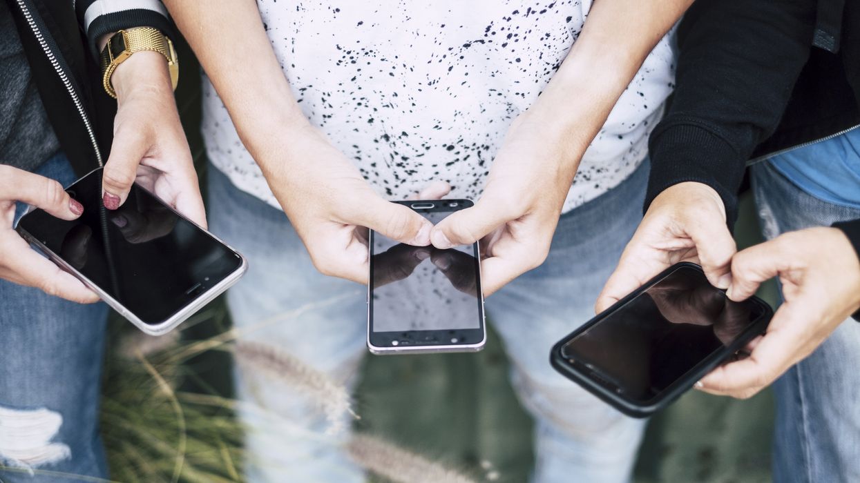 A group of people on their cell phones
