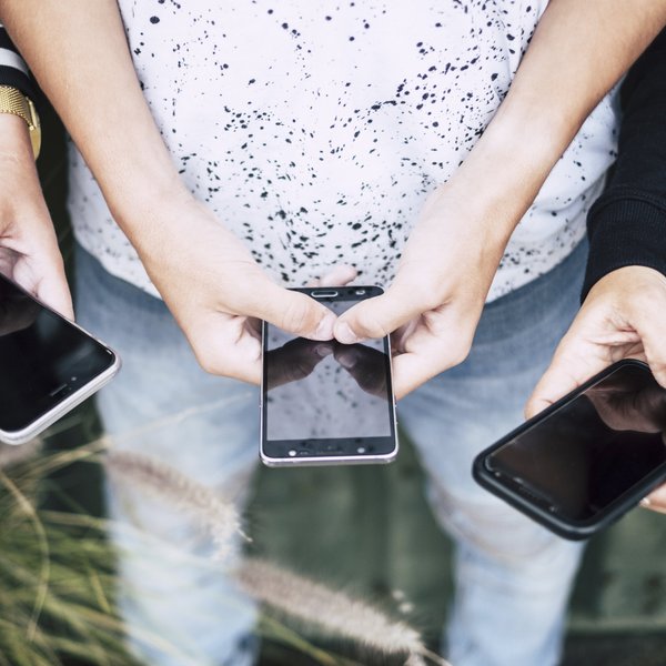 A group of people on their cell phones
