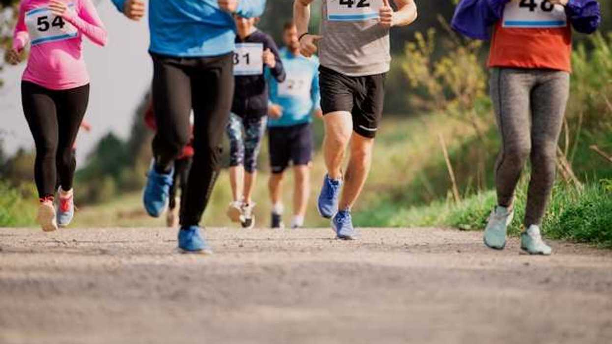 A group of runners wearing race bibs