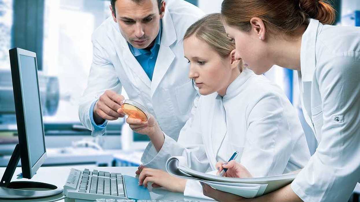 A group of scientists gathered around a computer