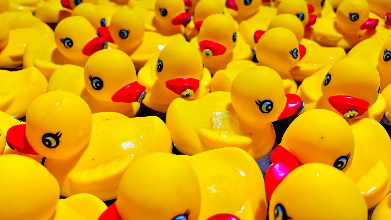 a group of small rubber ducks that are yellow and red
