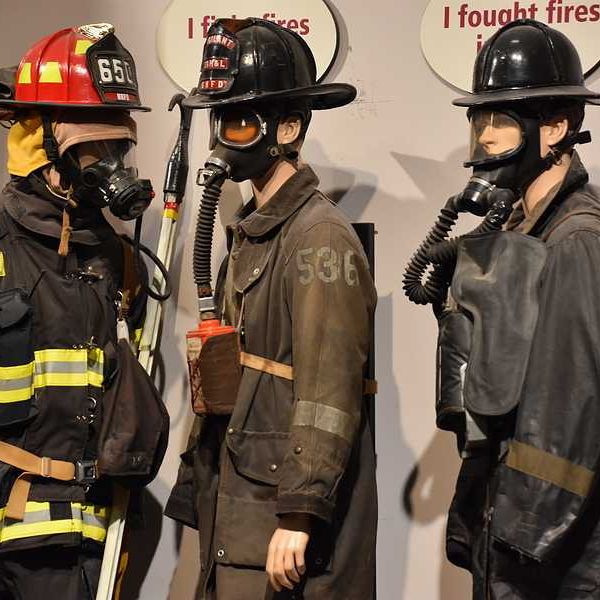 A group of three firefighter models wearing firefighting gear