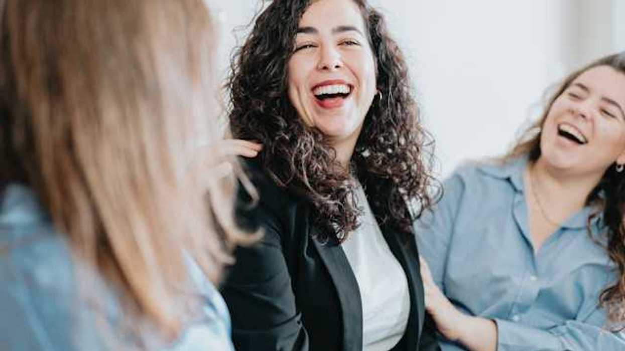 A group of three women laughing together