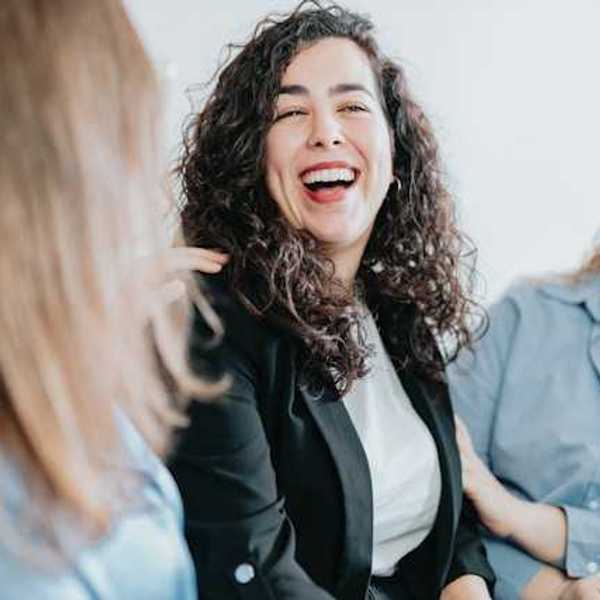 A group of three women laughing together