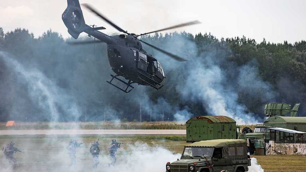 A helicopter landing at a military base