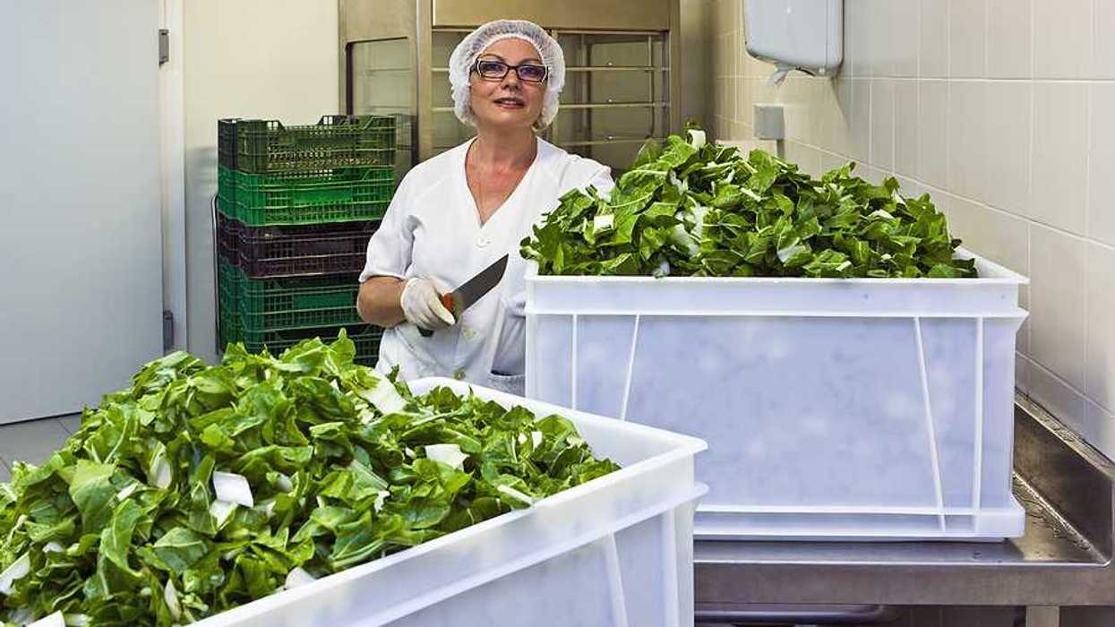 A hospital worker in a cafeteria kitchen