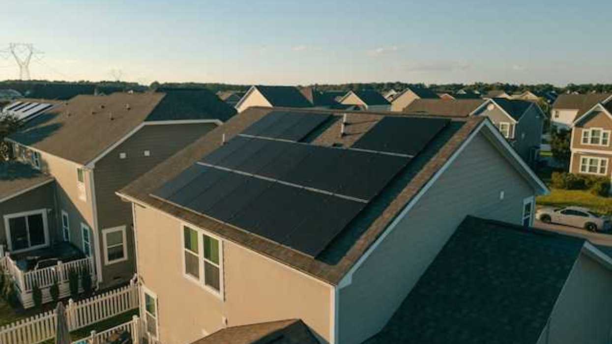 A housing tract with a house with solar panels on the roof
